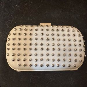 White clutch with silver embellishments with silver chain